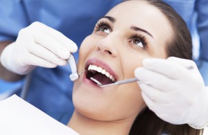 Woman having teeth examined at dentists